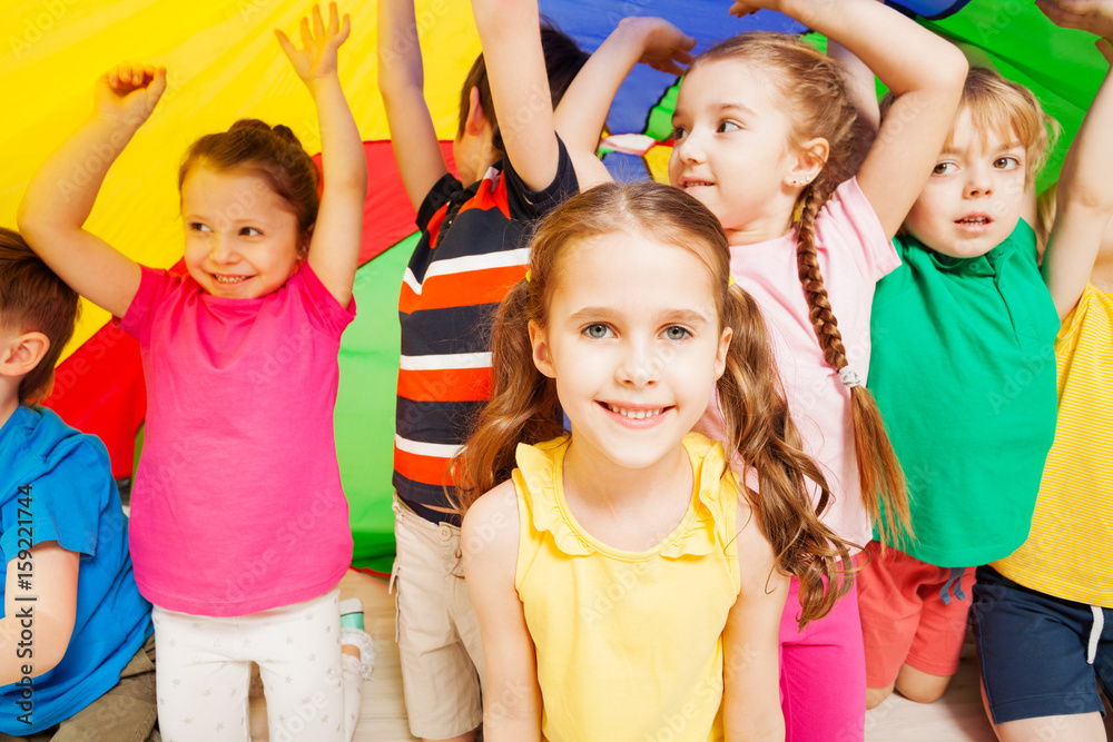 Children playing parachute during sports festival