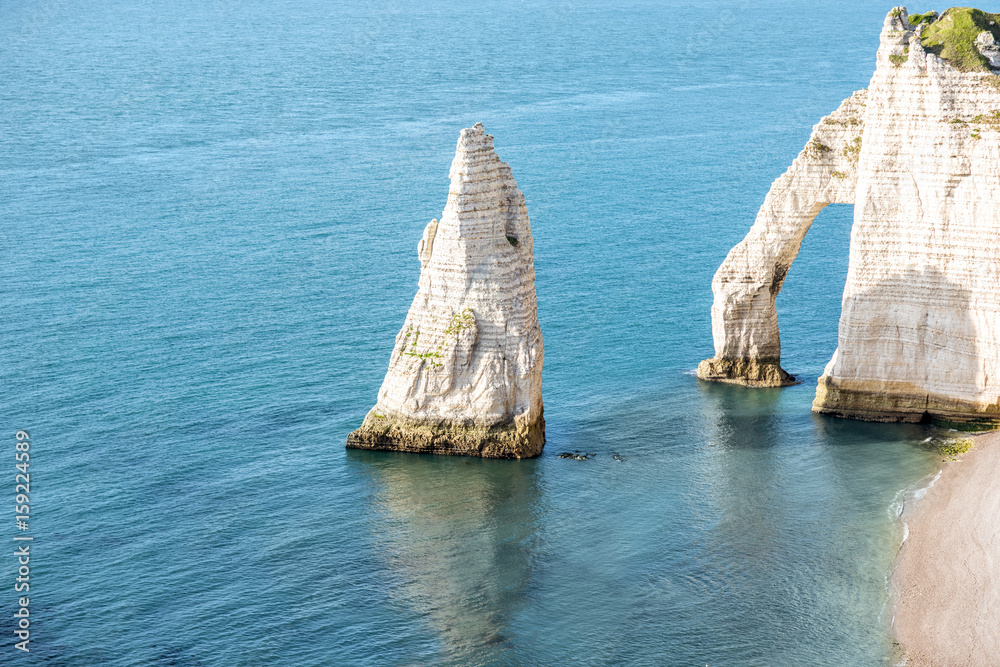 Landscape view on the famous rocky coastline near Etretat town in France during the sunny day