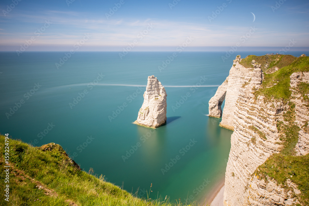 Landscape view on the famous rocky coastline near Etretat town in France during the sunny day. Long 