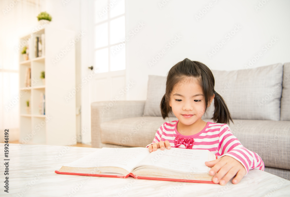 clever girl at table with reading books