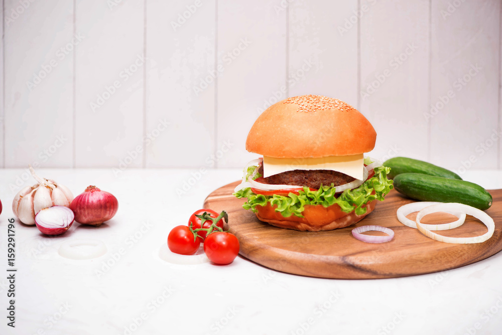 Homemade BBQ burger on wooden background.