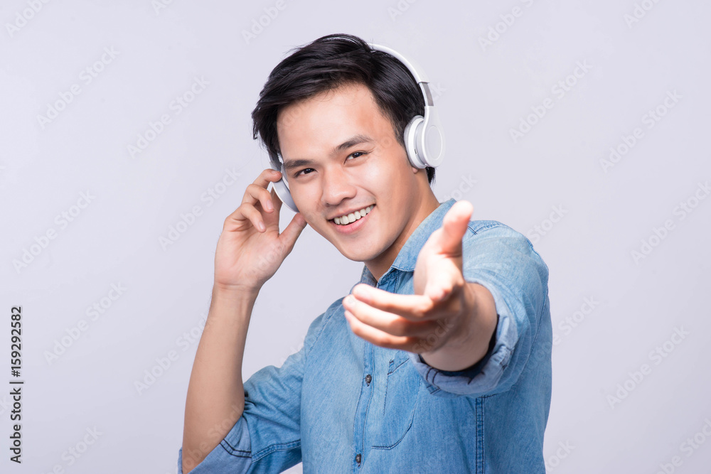 Smart casual asian man with headphone in studio background