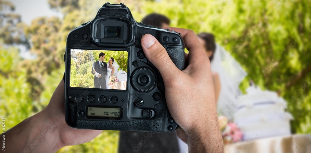 Composite image of cropped image of hands holding camera 