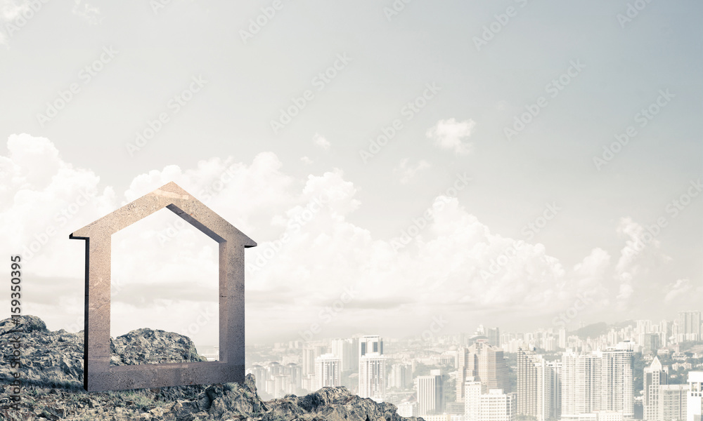 Conceptual image of concrete home sign on hill and natural lands