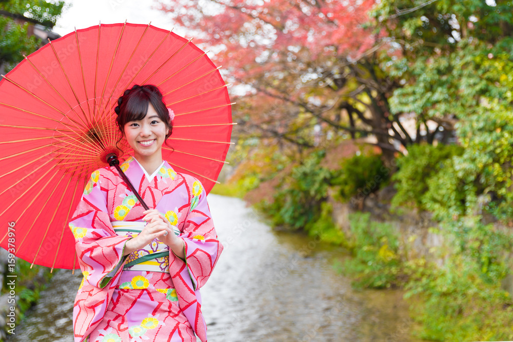 portrait of young asian woman waering kimono in autumn