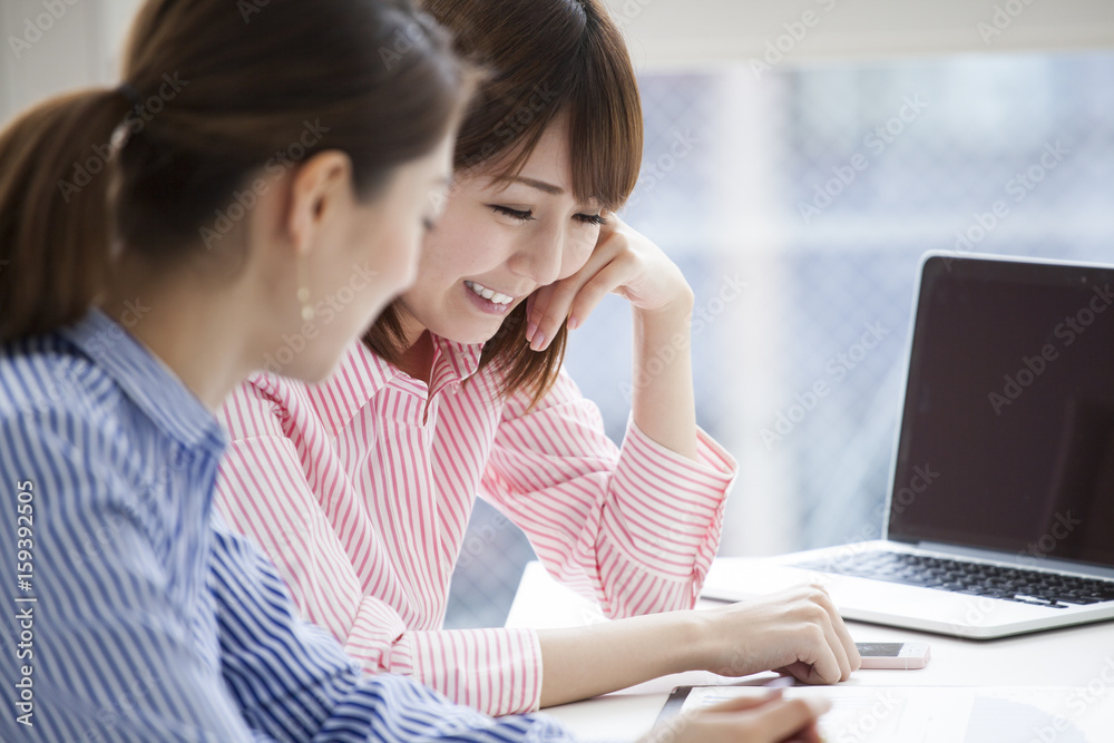 Women are having fun working in the office