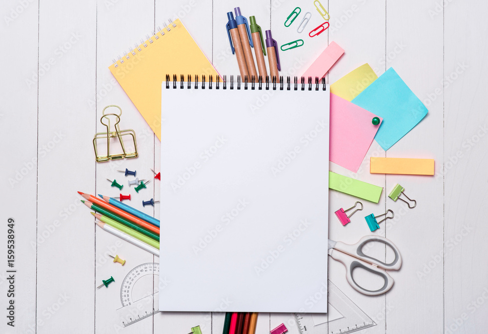 School stationery or office supplies on wood background.