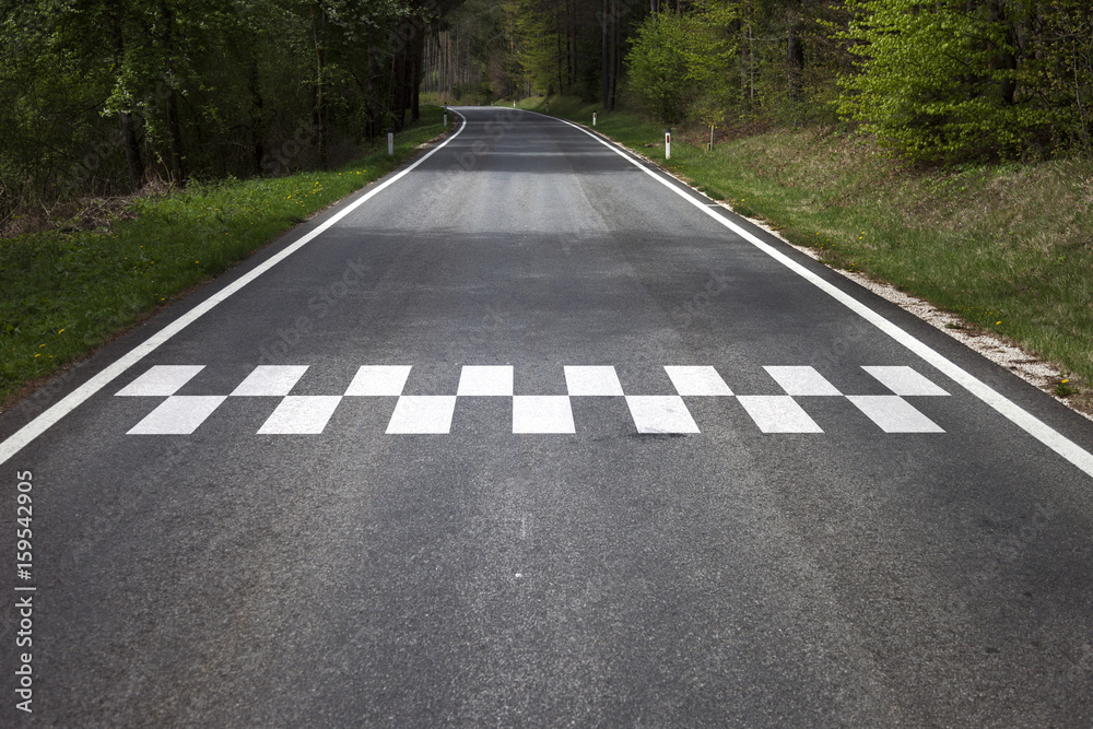 Concept start line pattern symbol painted on the countryside asphalt road floor.