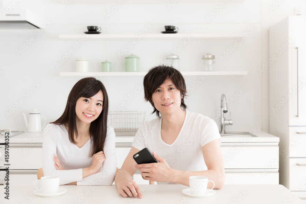 young asian couple relaxing in kitchen