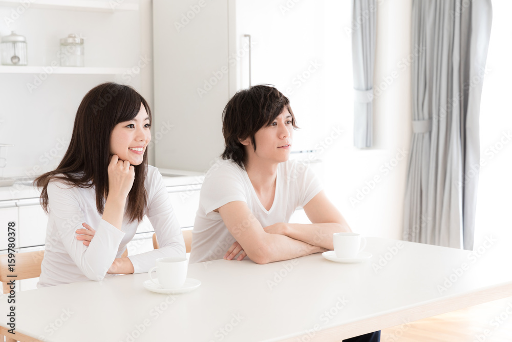 young asian couple relaxing in kitchen