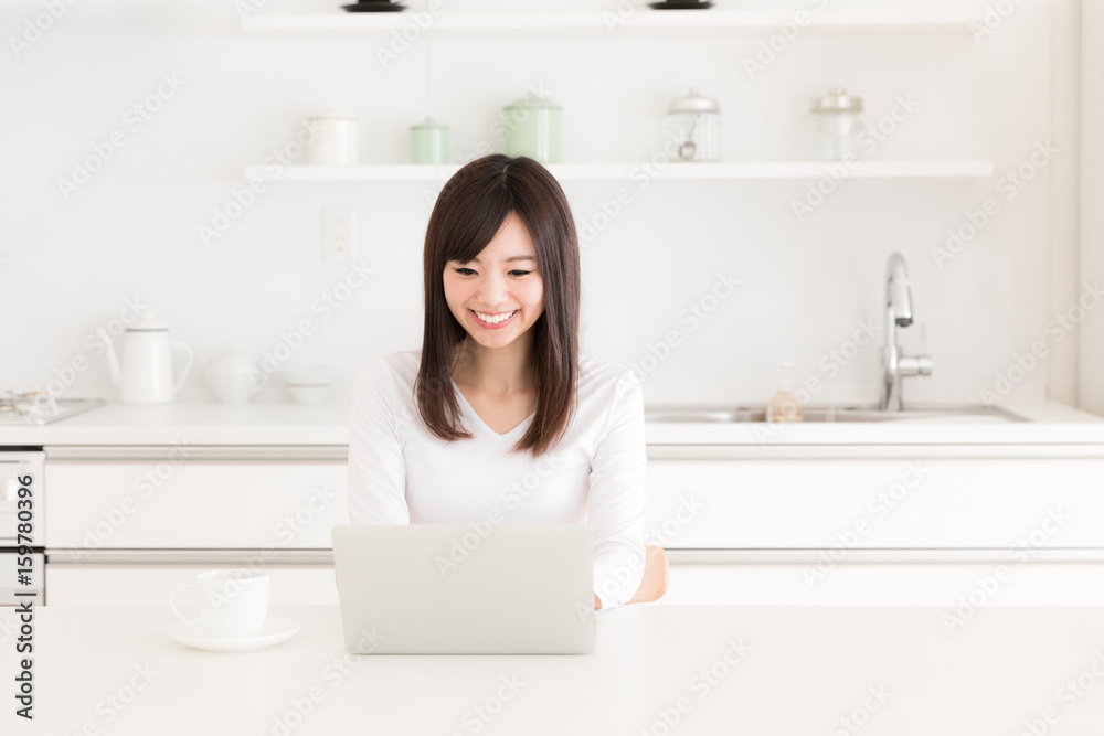 young asian woman relaxing in kitchen