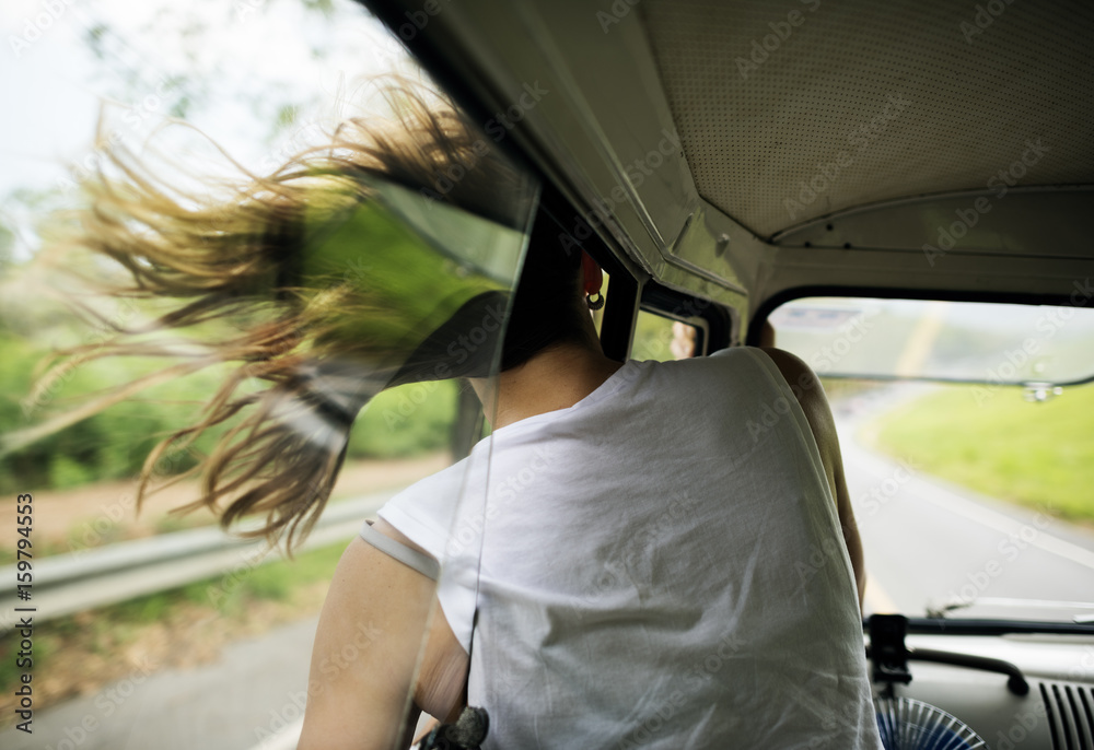 Woman Sitting in a Car Put Head Out of Window Wind Blowing Her Hair