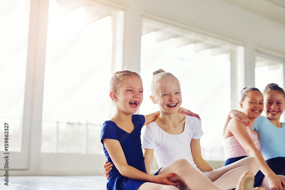 Little ballerinas having fun and embracing in ballet class