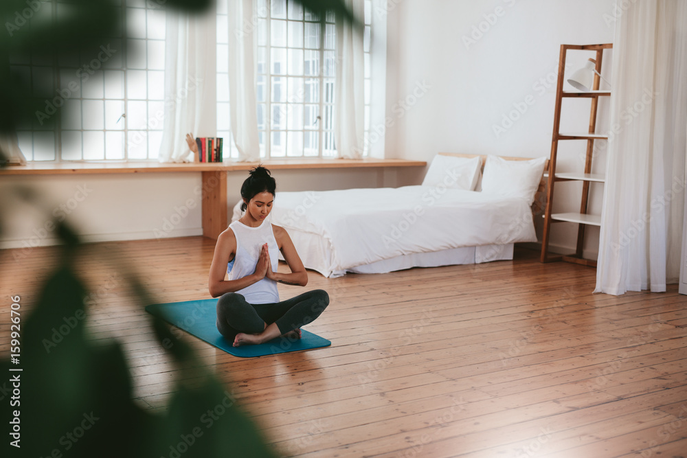 Beautiful young woman doing yoga exercise