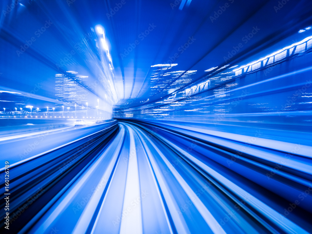 Motion blur train moving in city rail tunnel.