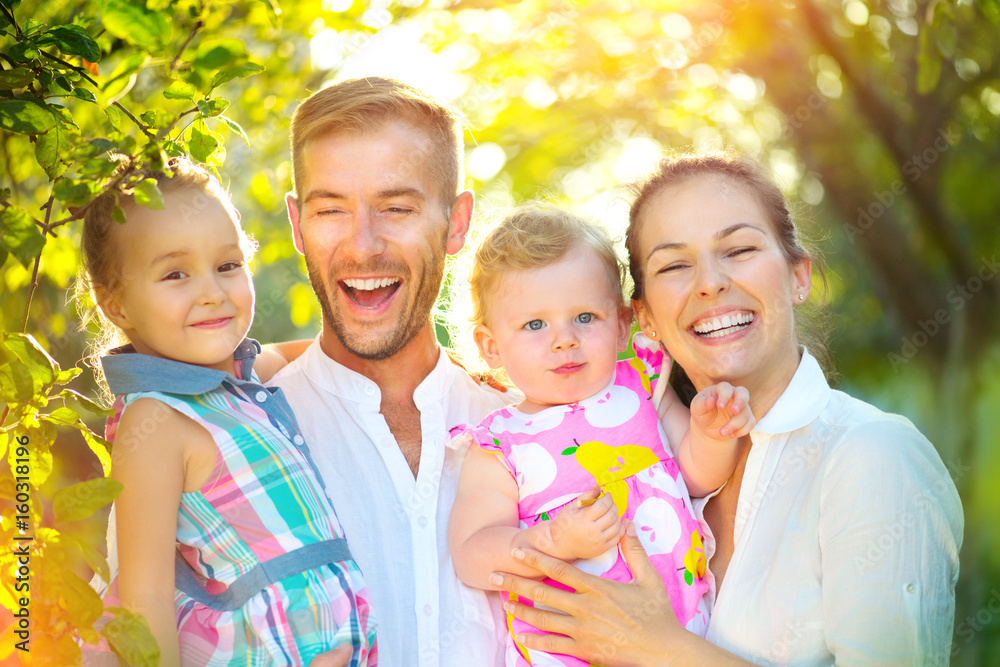 Happy joyful young family with little kids having fun outdoors