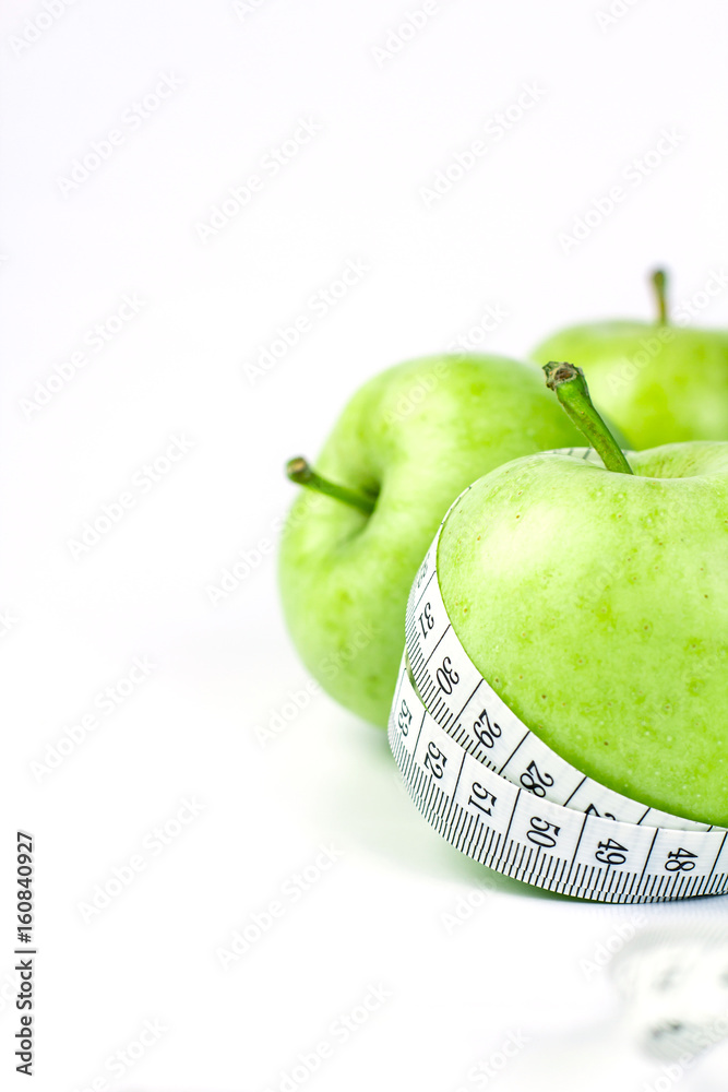 green apple with Measuring tape on white background in concept of healthy and diet