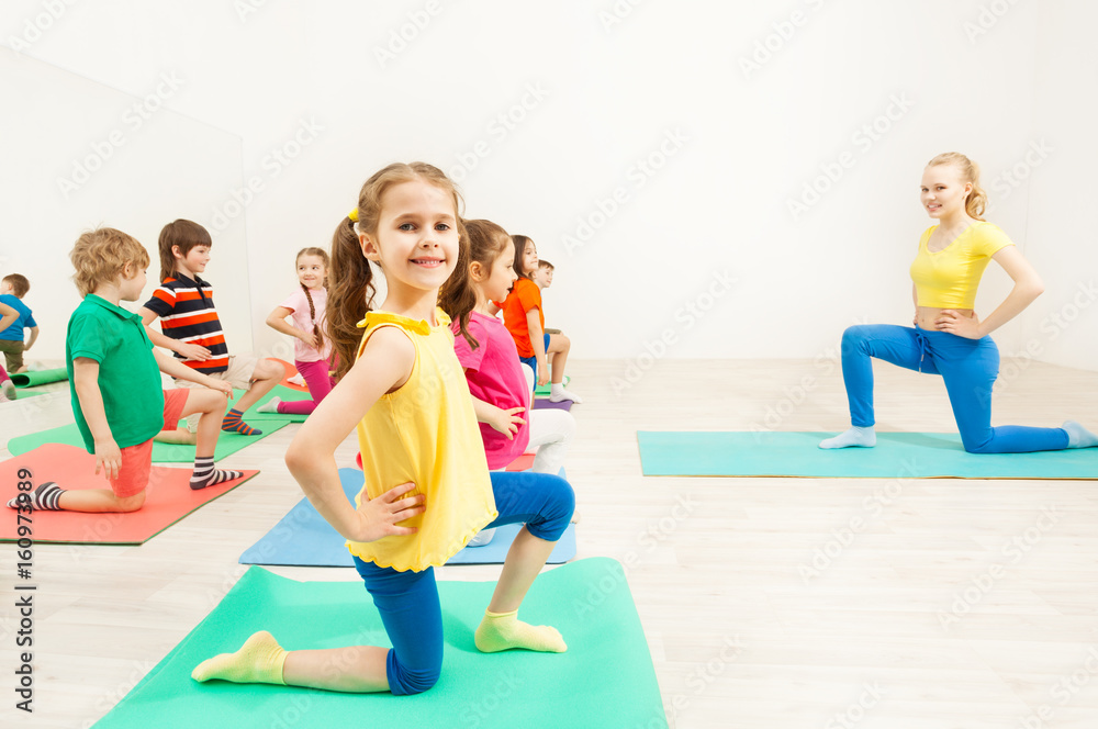 Girl standing on knee during gymnastic activity