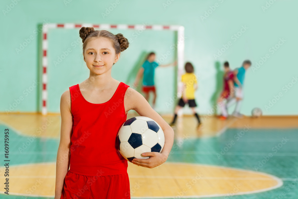 Girl standing with soccer ball during the match