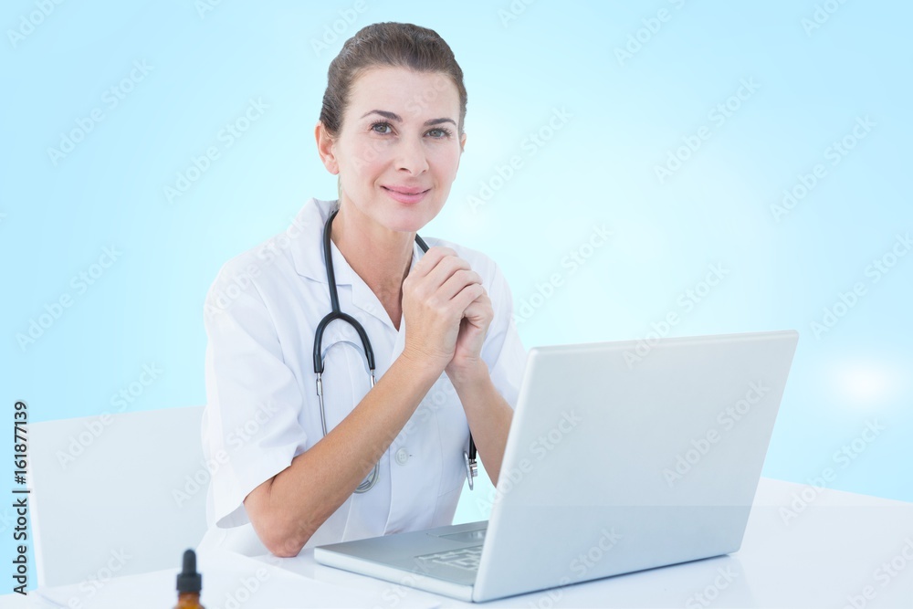 Composite 3d image of doctor with laptop on tab