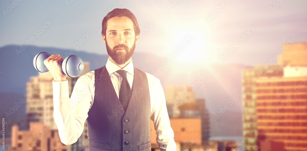 Composite image of portrait of businessman holding dumbbell