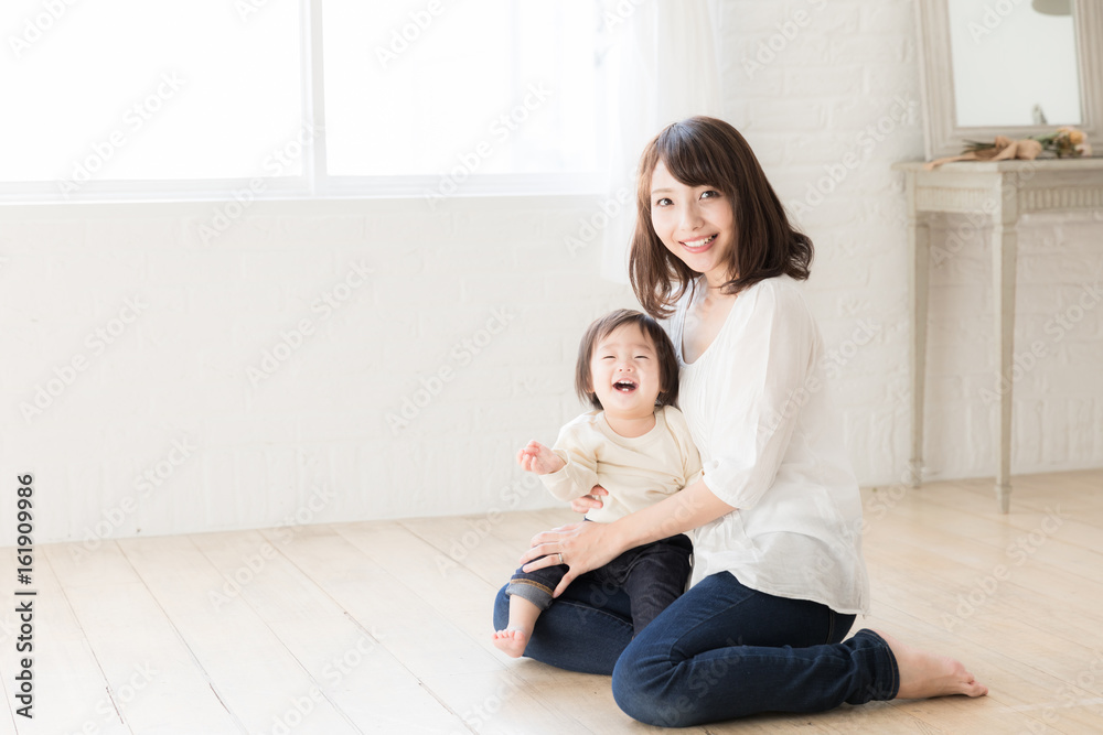 asian mother and child relaxing in living room