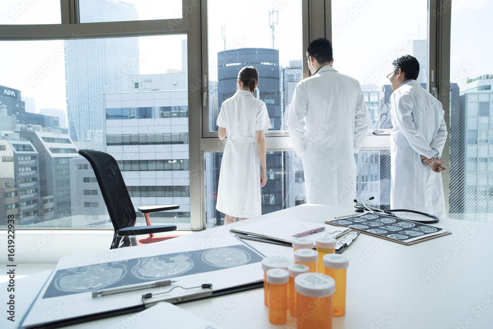 Doctors and nurses are looking out at the window