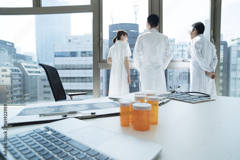 Doctors and nurses are looking out at the window