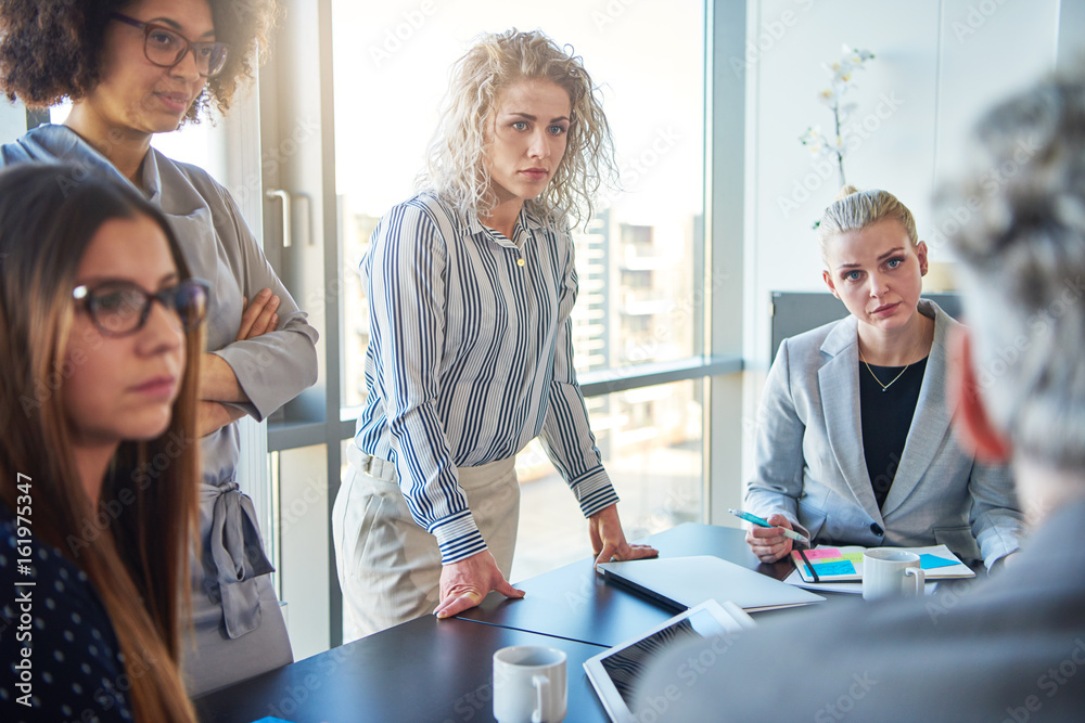 Focused business colleagues discussing strategy together in an office