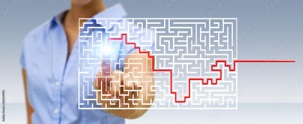 Businesswoman searching solution of a complicated maze