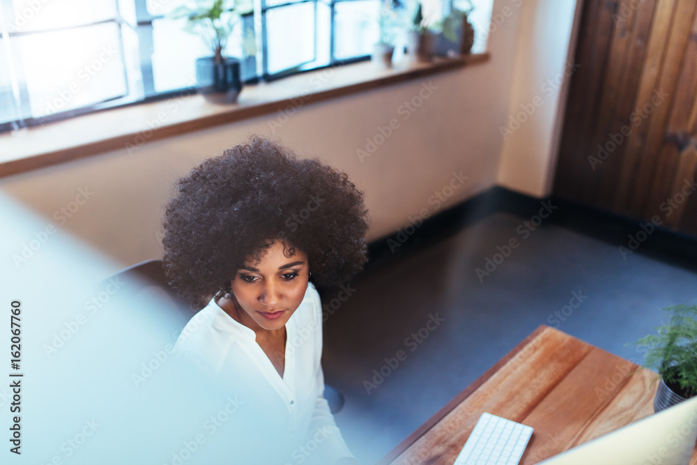 Young woman working at her office desk