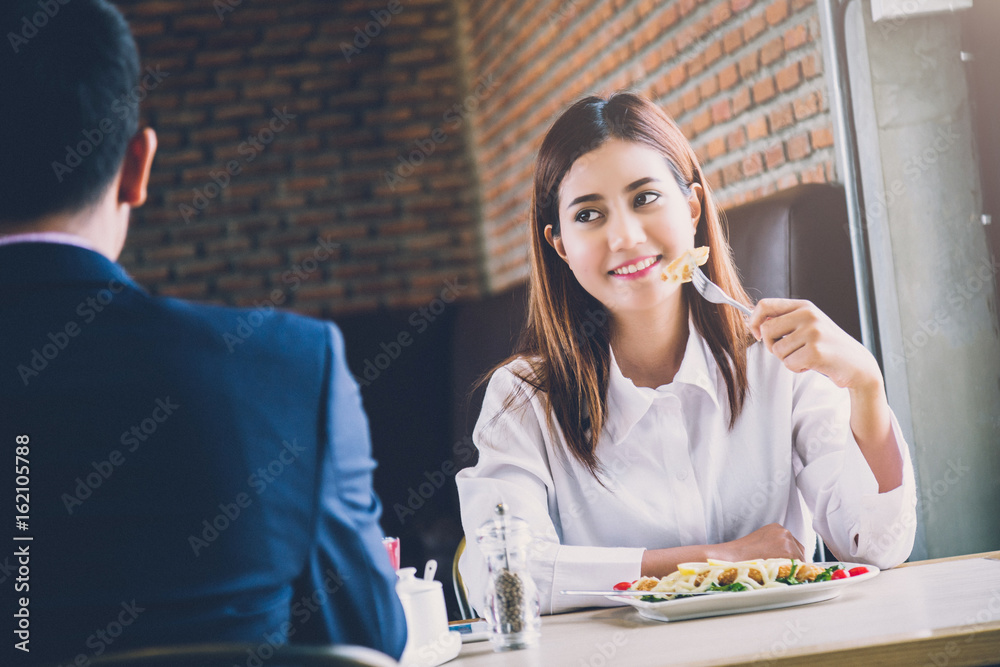 asian couple eating and laugh with love together at restaurant