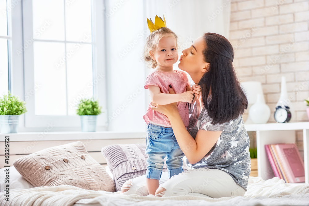 Mother and daughter playing and hugging