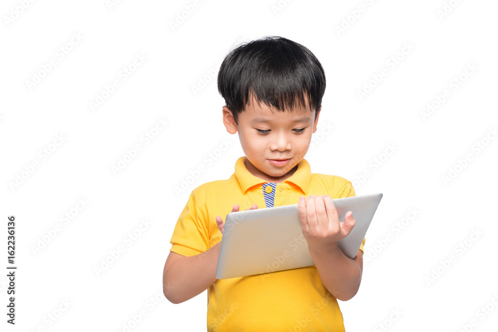 Funny asian boy holding a tablet computer