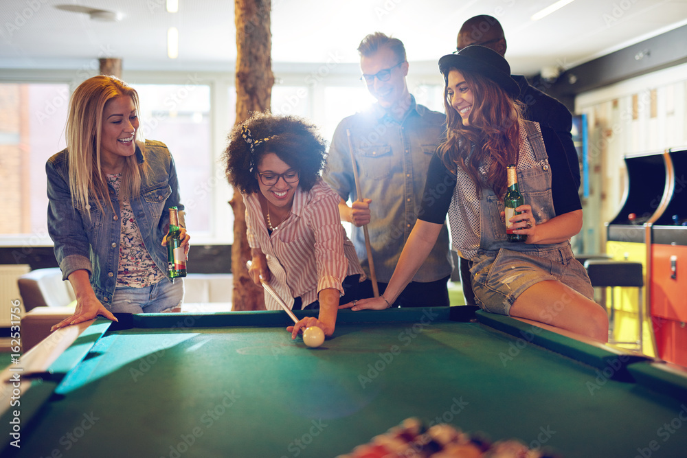 Woman behind the cue ball while friends watch