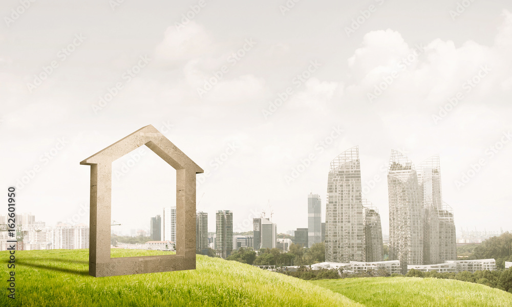 Conceptual image of concrete home sign on hill and natural lands