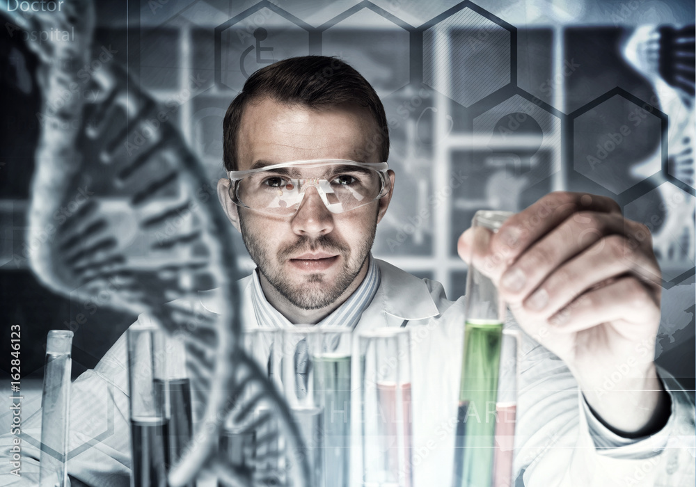 Young scientist mixing reagents in glass flask in clinical laboratory