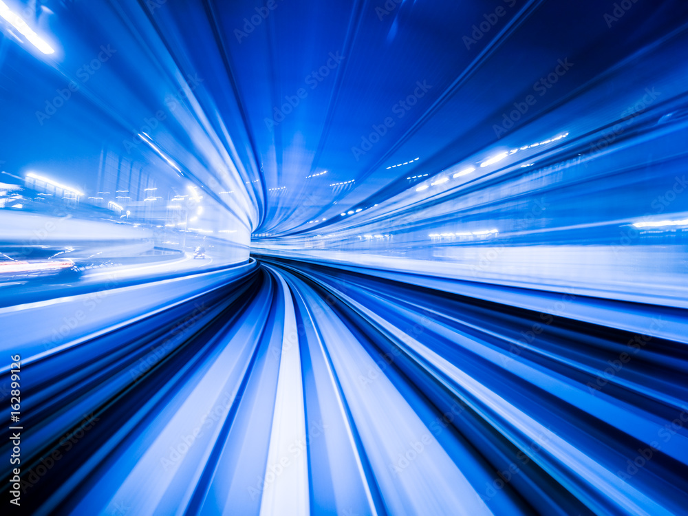 Motion blur train moving in city rail tunnel.