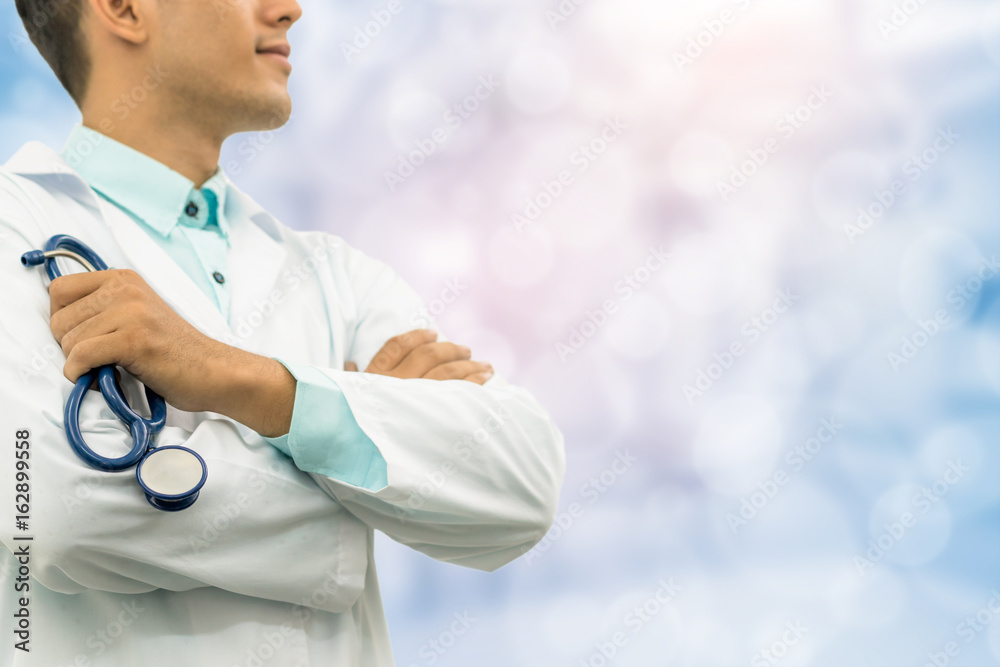 Male doctor holding stethoscope in the hospital