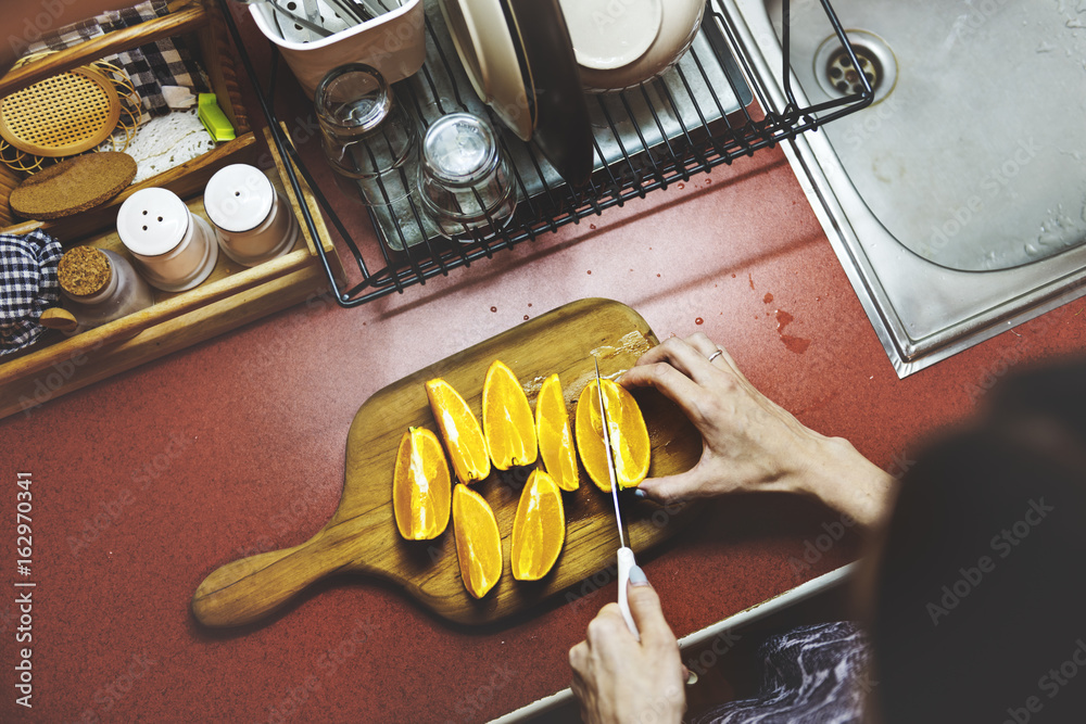 A sliced orange is on a wooden cutting board.