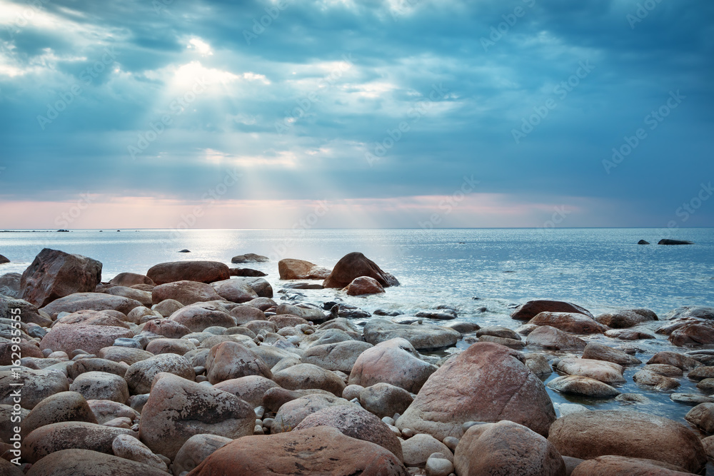 Rocky shores at the sea in sunset light. Lahemaa natural park coastal landscape with beautiful sky