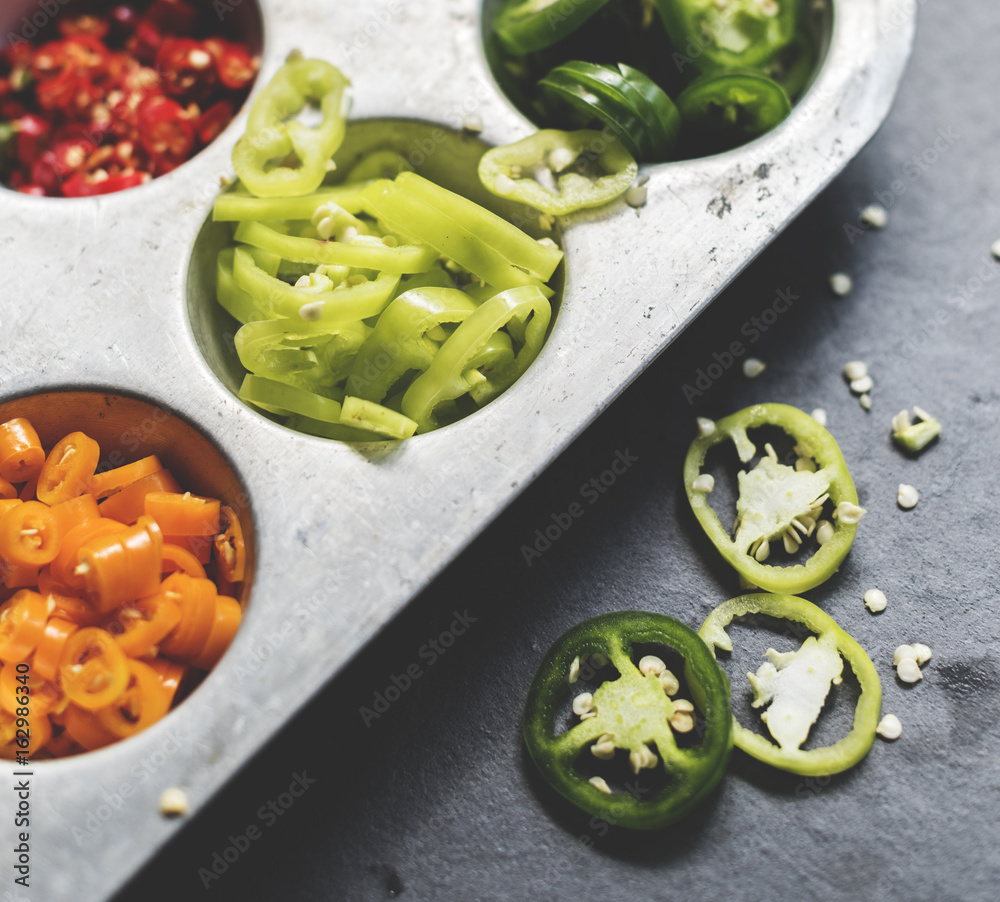 Closeup of cut chili peppers in metal tray