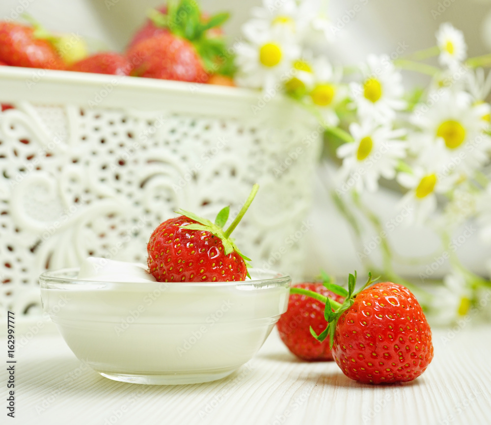 Beautiful juicy bright appetizing strawberry berries with whipped cream on a light background with d