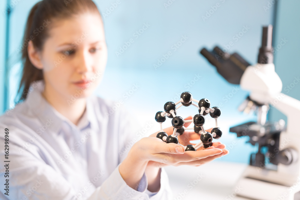 scientist woman holding molecule model