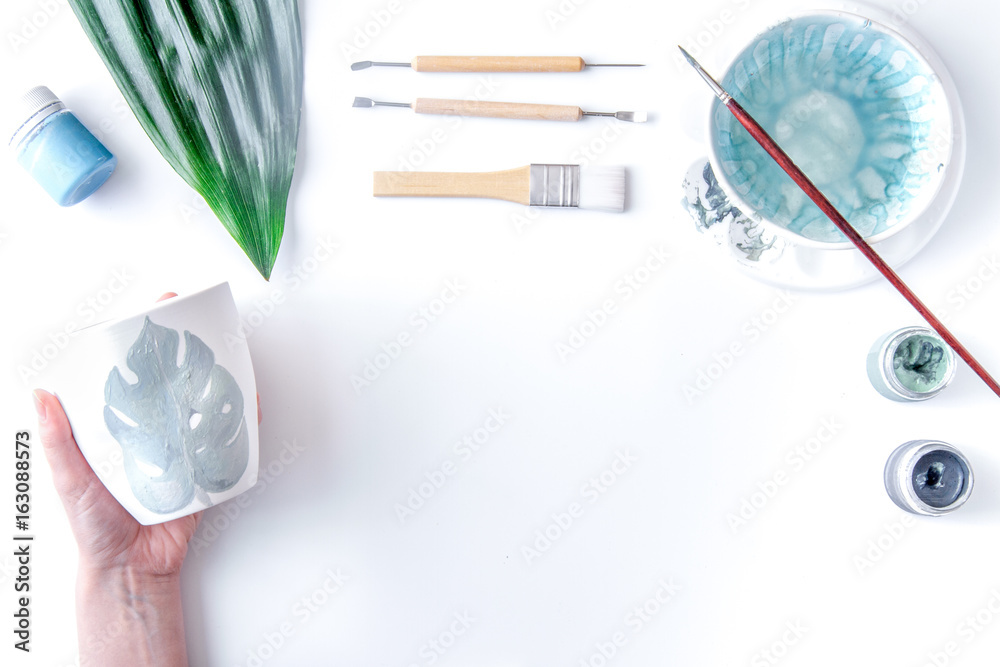 painted ceramic cup on white background top view