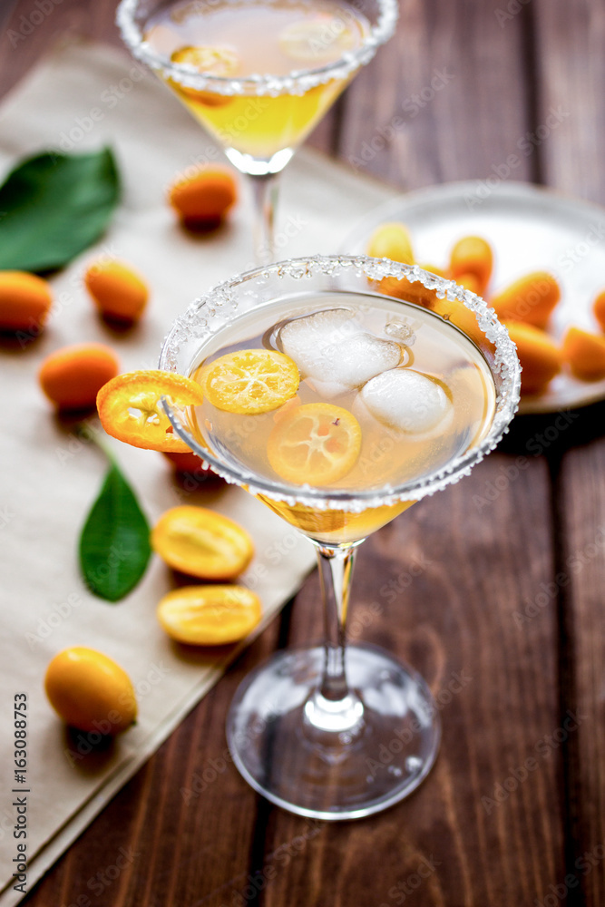 cocktail with kumquat on wooden background