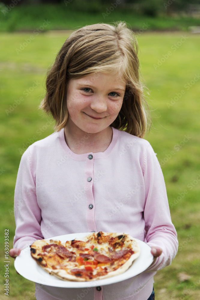 Child Holding Plate Pizza Concept