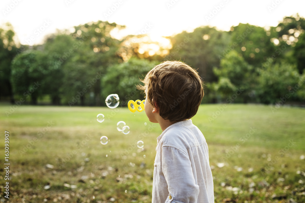 Children is playing bubbles in a park