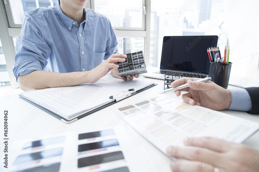 Men are thinking about the color of the buildings outer wall