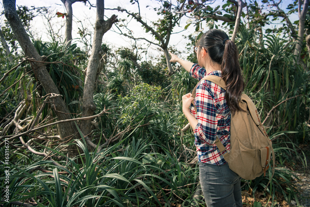 back view photo of beautiful young woman hiker